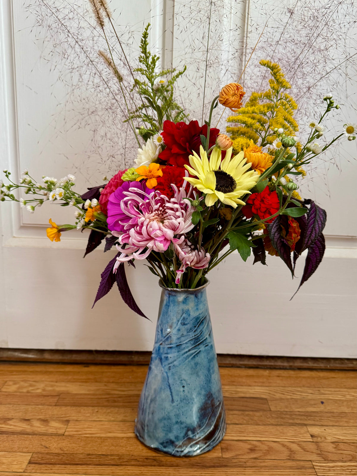 Tall ceramic vase with flowers