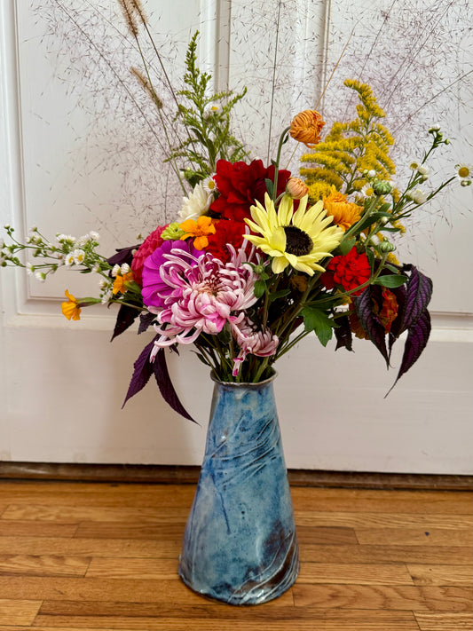 Tall ceramic vase with flowers